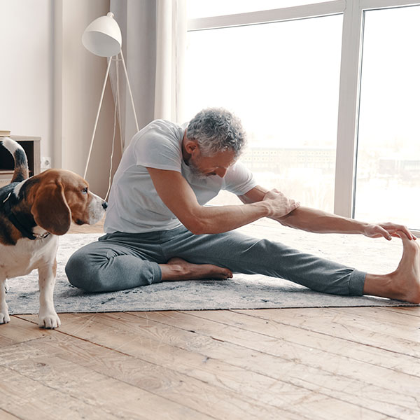 Shoulder Replacement Surgery Man stretching while dog watching next to him